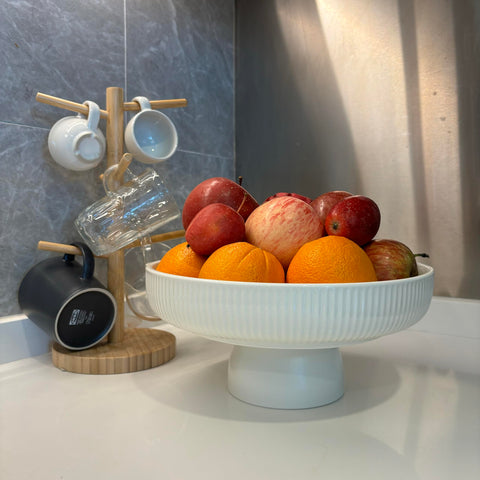 JolieJulie size comparison with apple and spoon showing real-world scale and usefulness