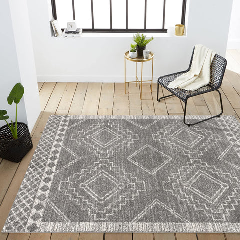 JONATHAN Y rug layered in bedroom creating cozy, low-profile bedside area