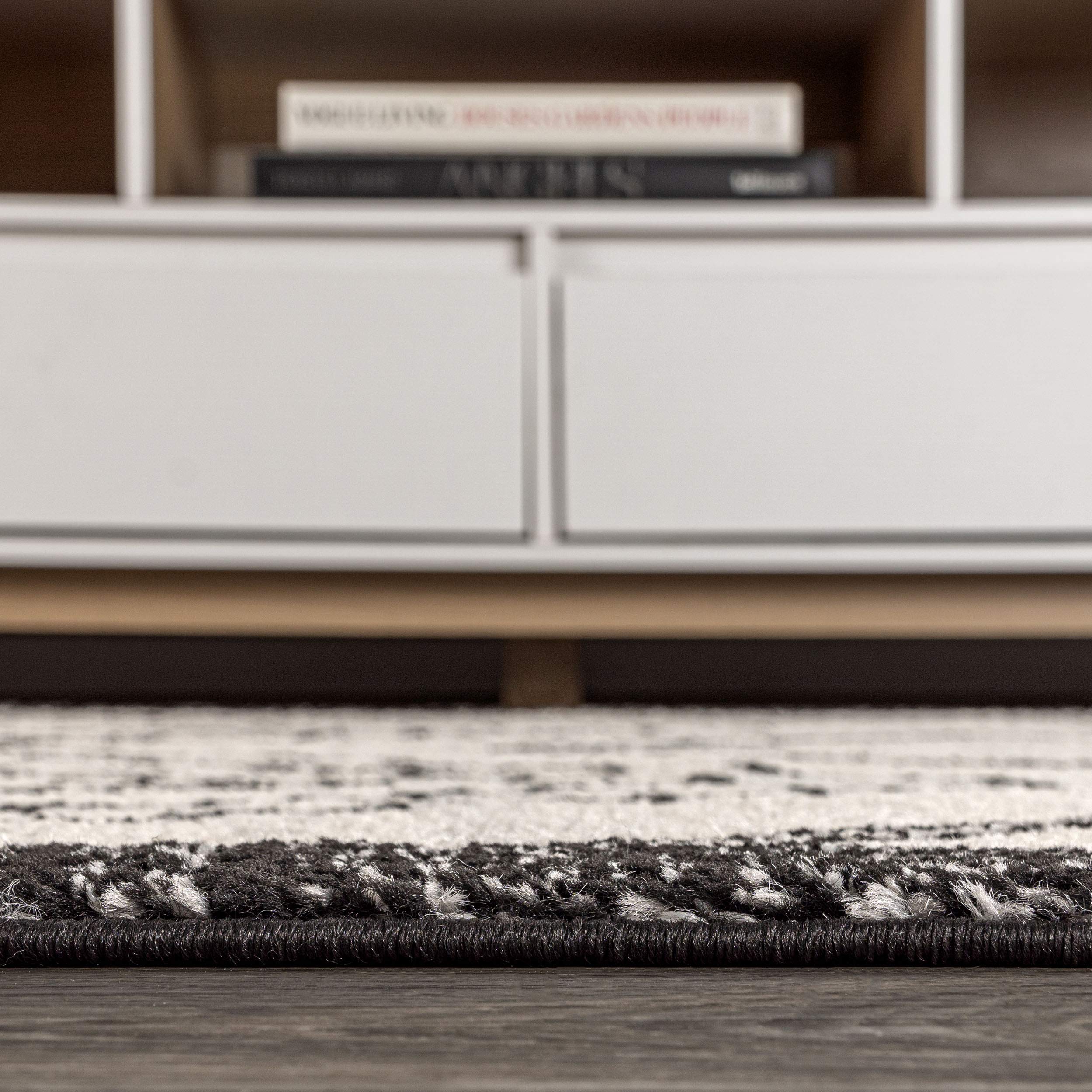 JONATHAN Y rug next to chair showing 4x6 scale for small seating areas