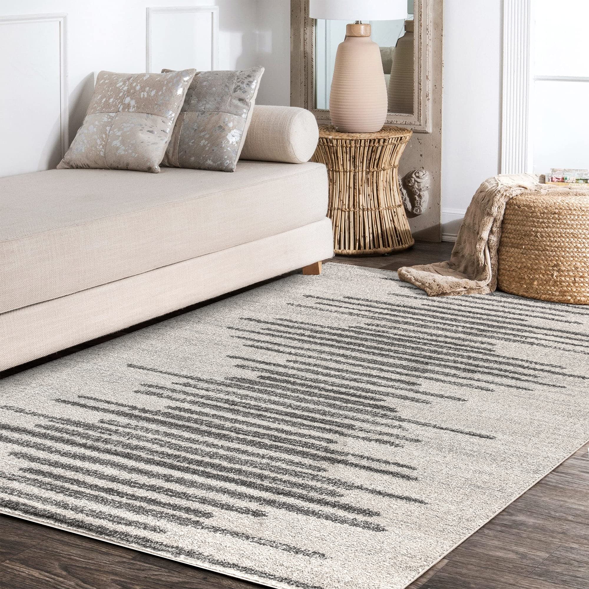 JONATHAN Y rug beside sofa for scale, shows compact 3x5 size versatility