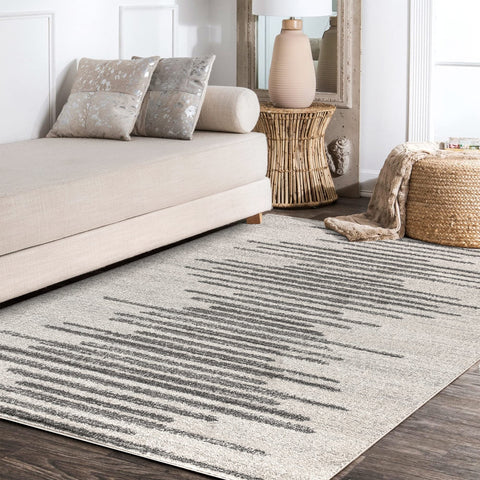JONATHAN Y rug beside sofa for scale, shows compact 3x5 size versatility