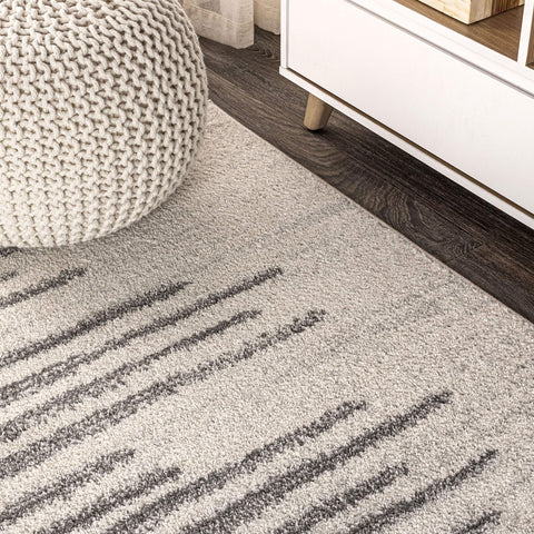 JONATHAN Y rug under coffee table, anchors seating area with subtle stripes
