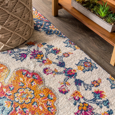 JONATHAN Y rug beside chair for scale — shows true 5x8 proportions