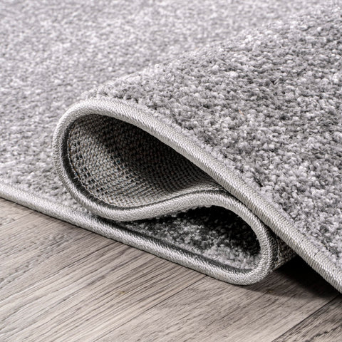 JONATHAN Y rug under bed in bedroom creating calm minimalist look