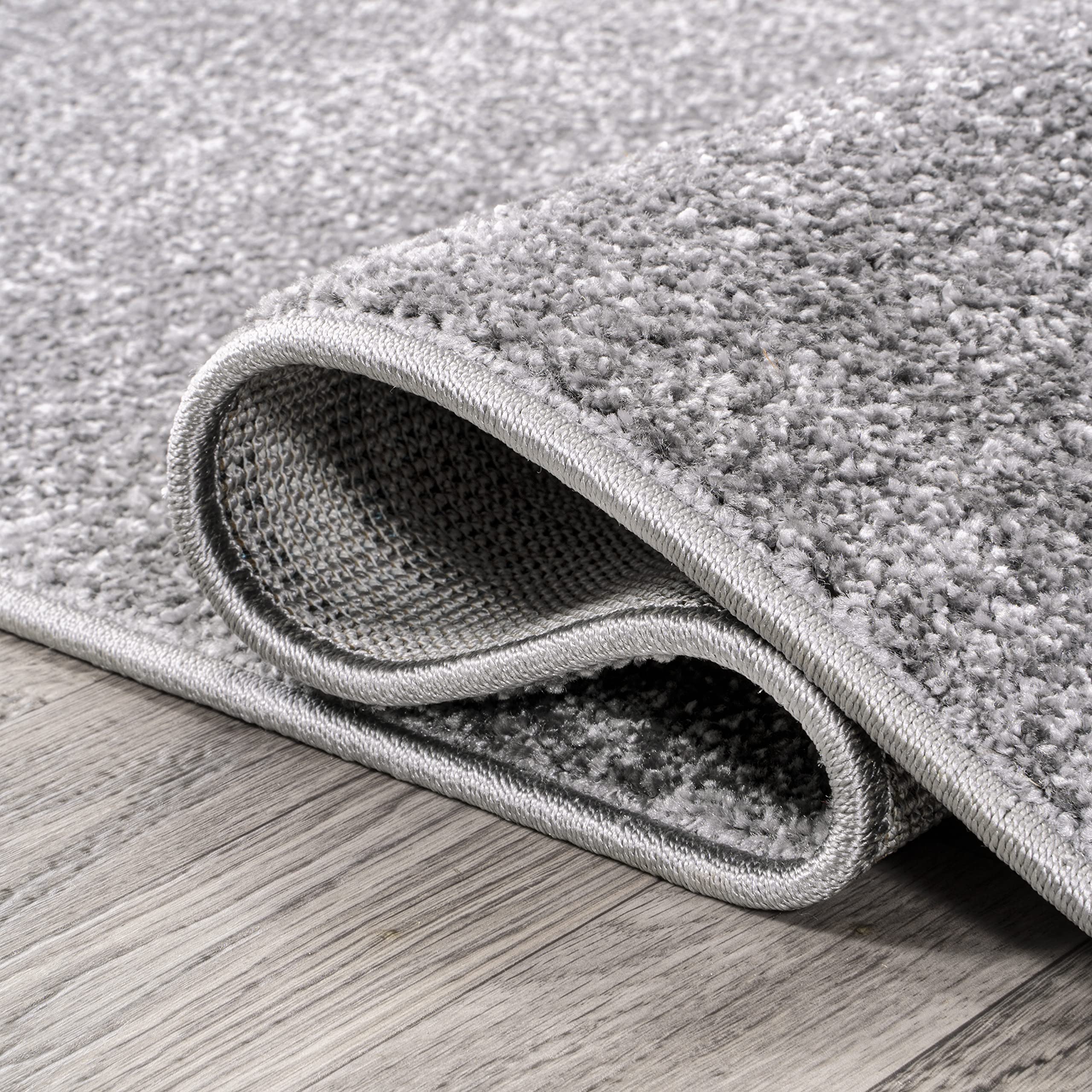 JONATHAN Y rug placed beside bed delivering soft step-out surface and calm tone