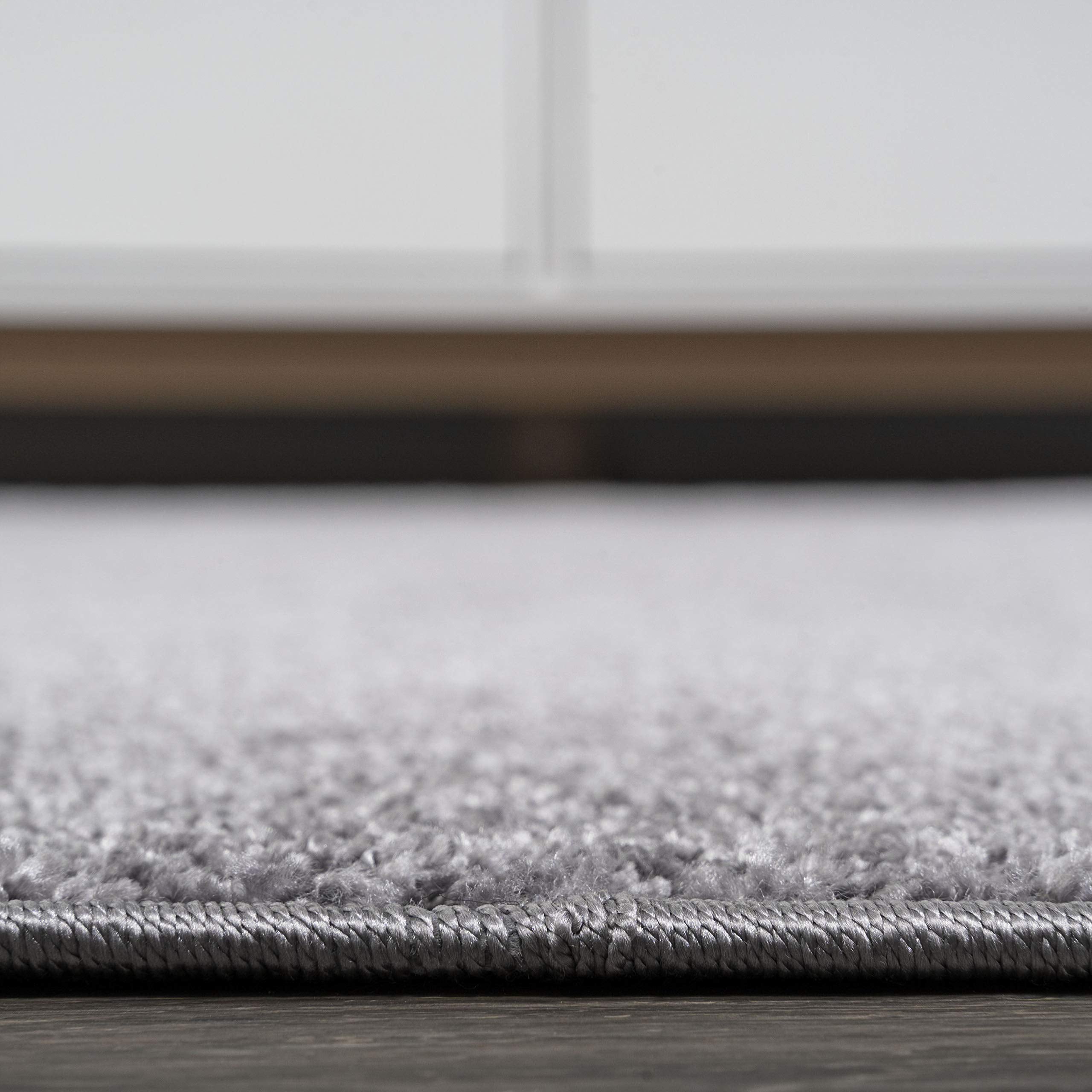 JONATHAN Y hands spot-cleaning rug showing easy-care stain removal method