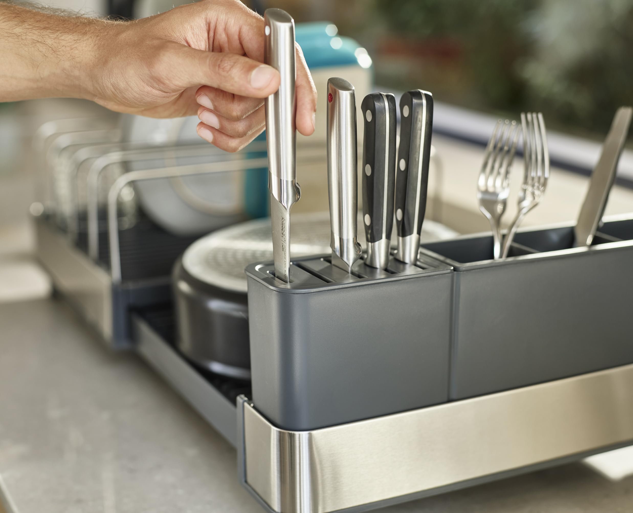 Joseph Joseph dish rack in a modern kitchen drying mixed cookware and saving counter space