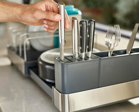 Joseph Joseph dish rack in a modern kitchen drying mixed cookware and saving counter space
