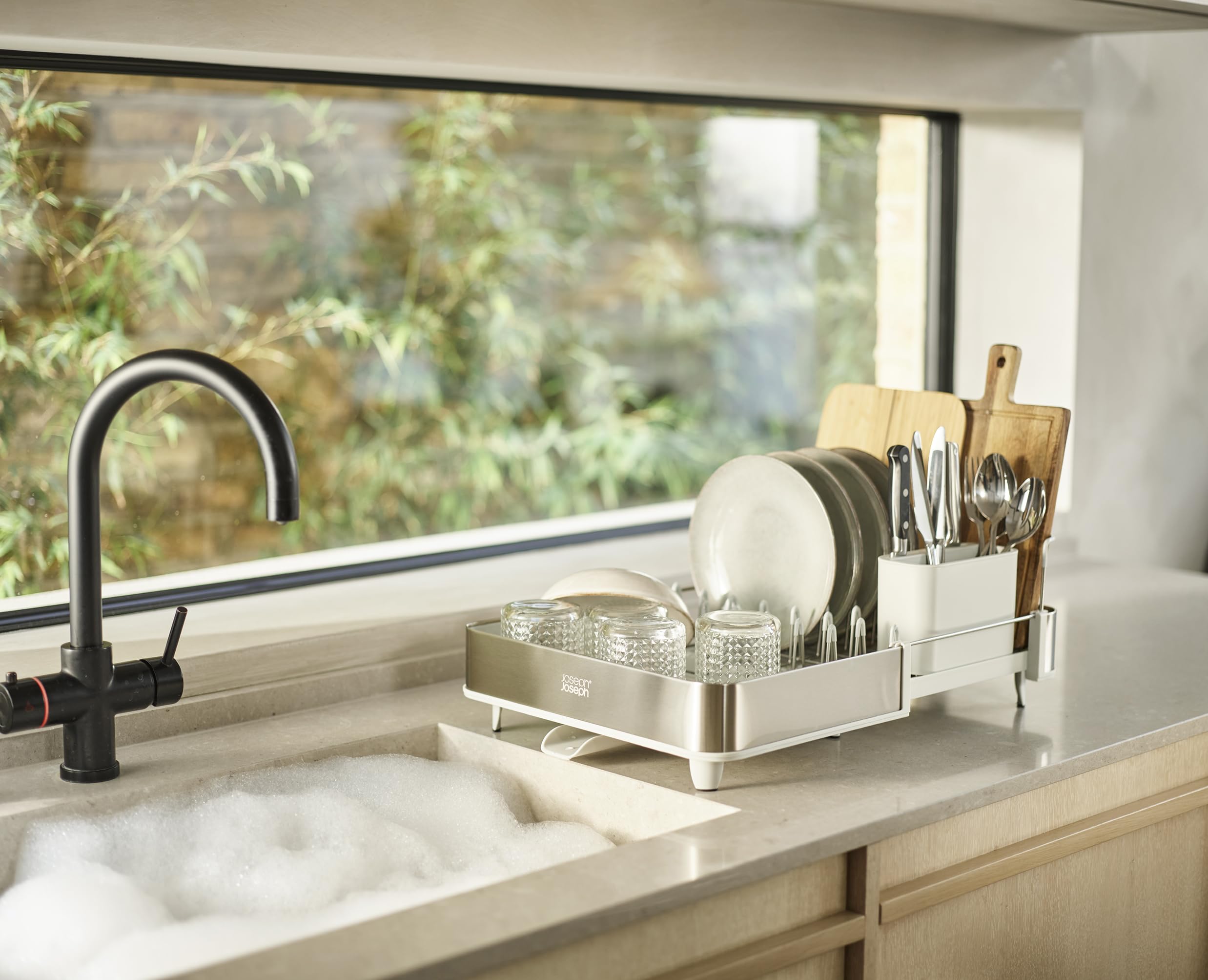 Joseph Joseph drying rack on kitchen counter in use keeps countertops tidy while air-drying dishes benefit