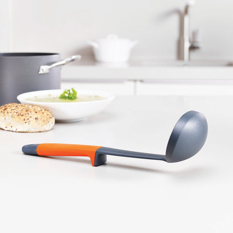 Joseph Joseph flexible turner bending to slide under food for safe lifting in pans