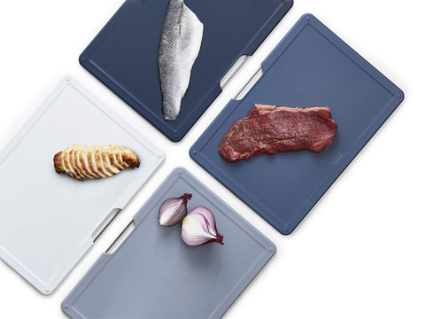 Joseph Joseph board in use chopping vegetables to demonstrate hygienic food separation benefit