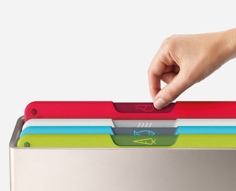 Joseph Joseph board held in hand showing 24x34cm scale and compact convenience