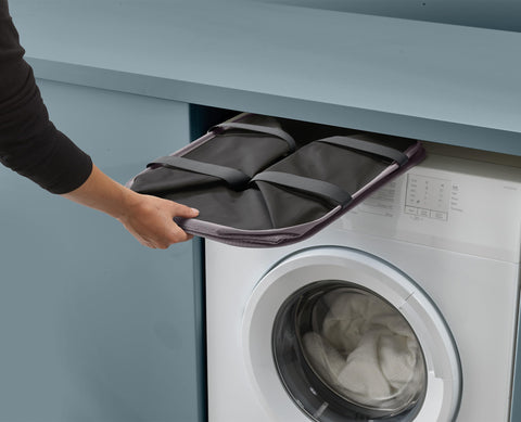 Joseph Joseph next to washing machine showing scale and space-saving benefit