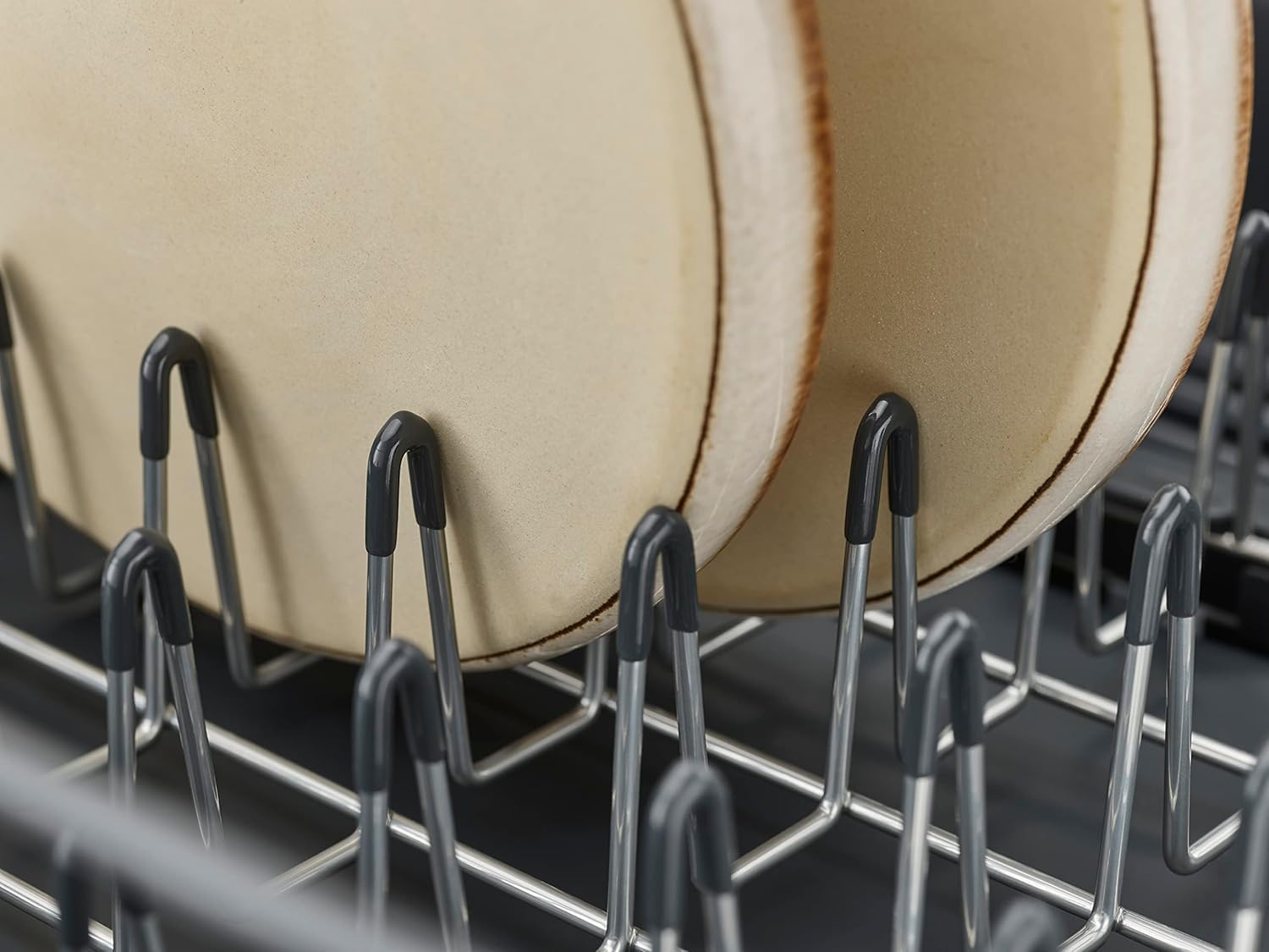 Joseph Joseph movable cutlery drainer close-up showing easy repositioning benefit