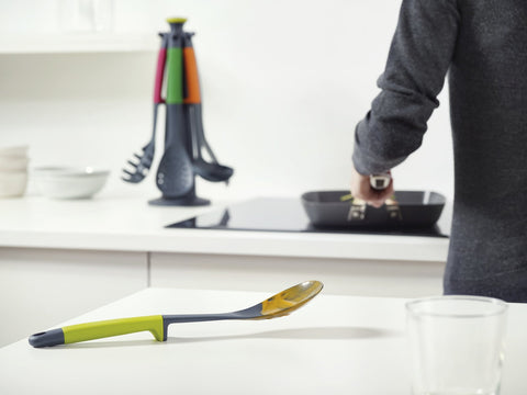 Joseph Joseph slotted spoon head detail showing drain slots and gentle cookware contact