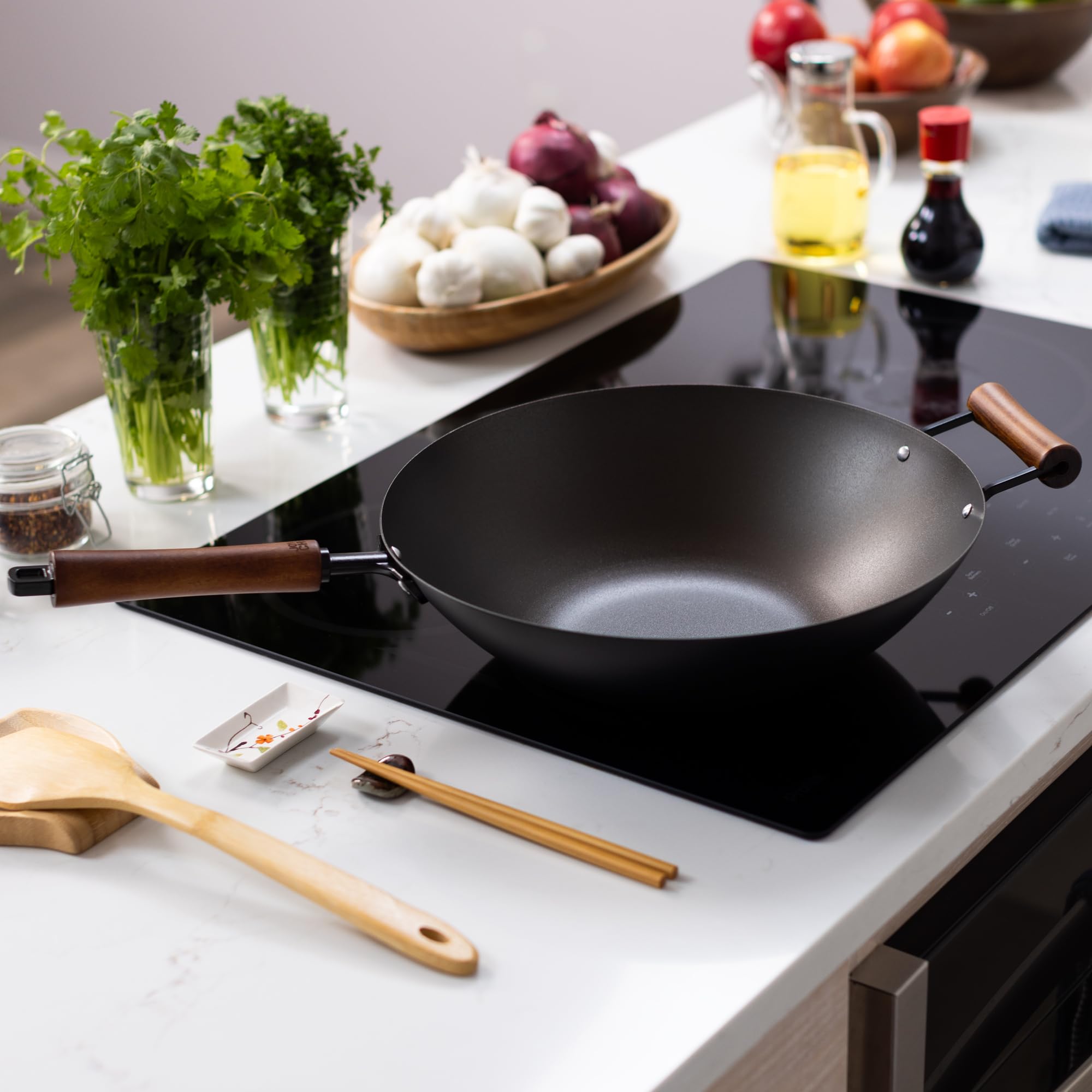 JOYCE CHEN size comparison next to skillet illustrating 14-inch capacity for family meals