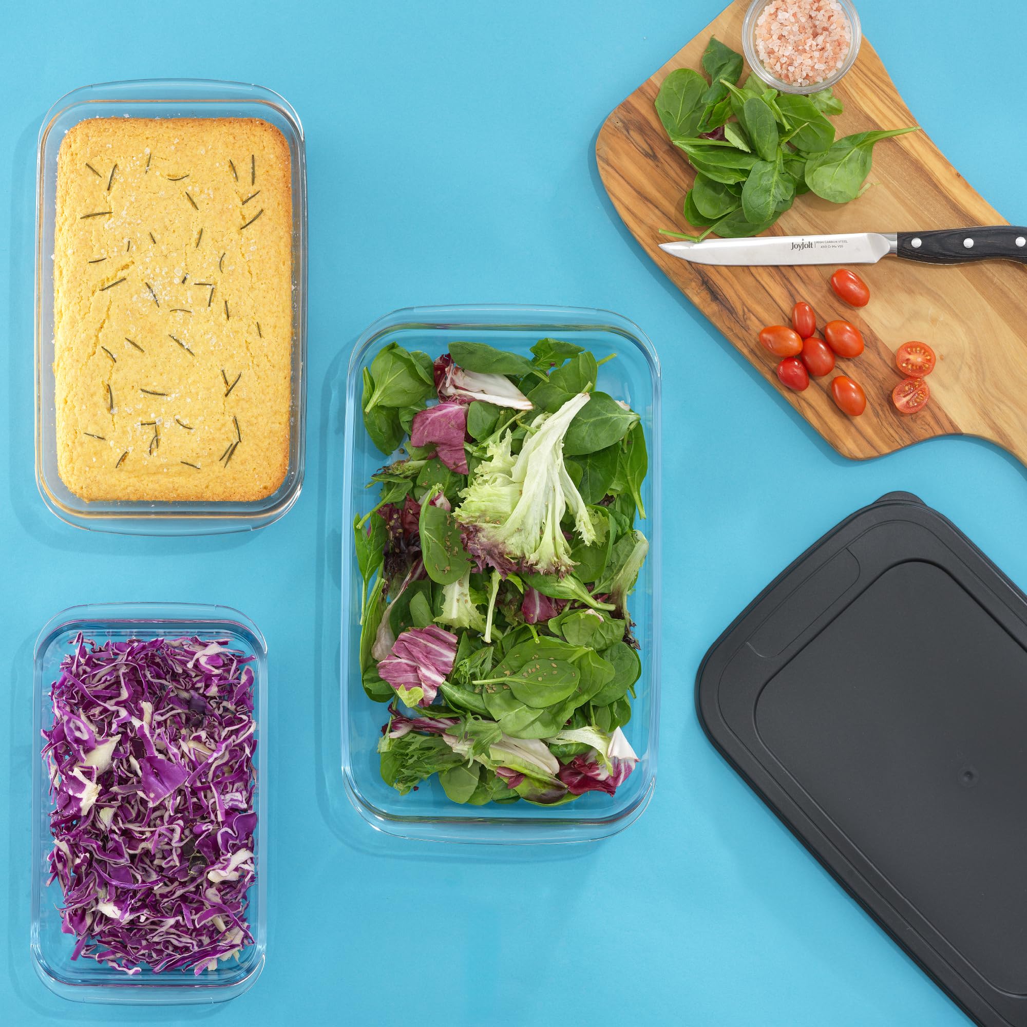 JoyJolt stacked dishes in refrigerator with prepared meals showing space-saving meal-prep convenience