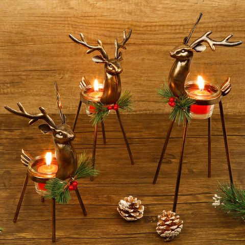 Juegoal front view of three reindeer holders showing bronze finish and glass cups for festive tables