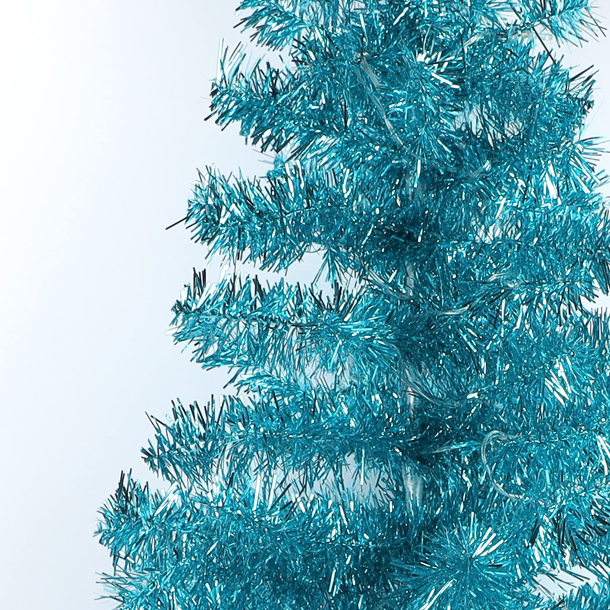 Juegoal tree beside sofa showing 4 ft scale for small-space placement