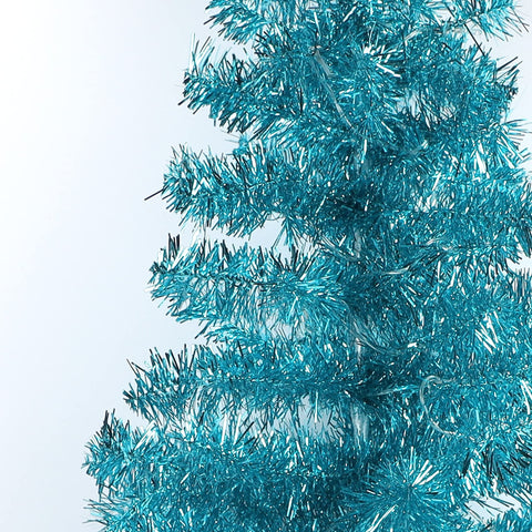 Juegoal tree beside sofa showing 4 ft scale for small-space placement