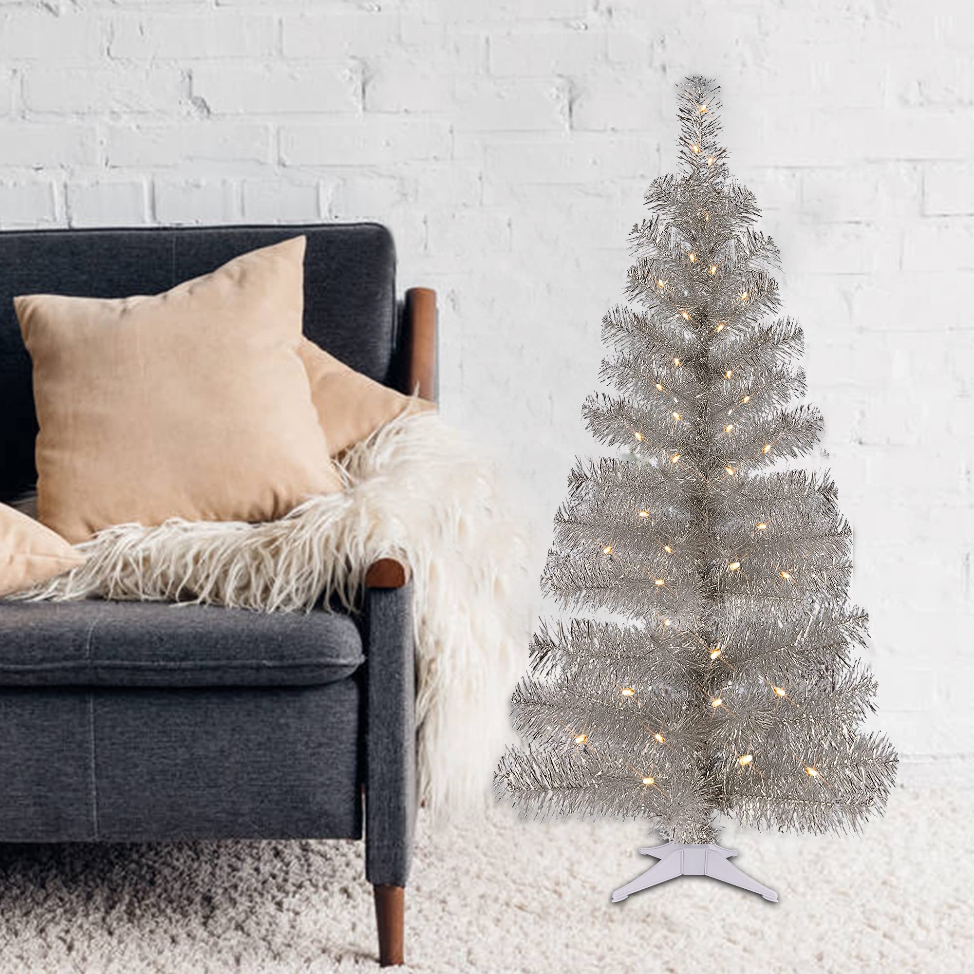 Juegoal tree size comparison next to sofa showing compact footprint advantage