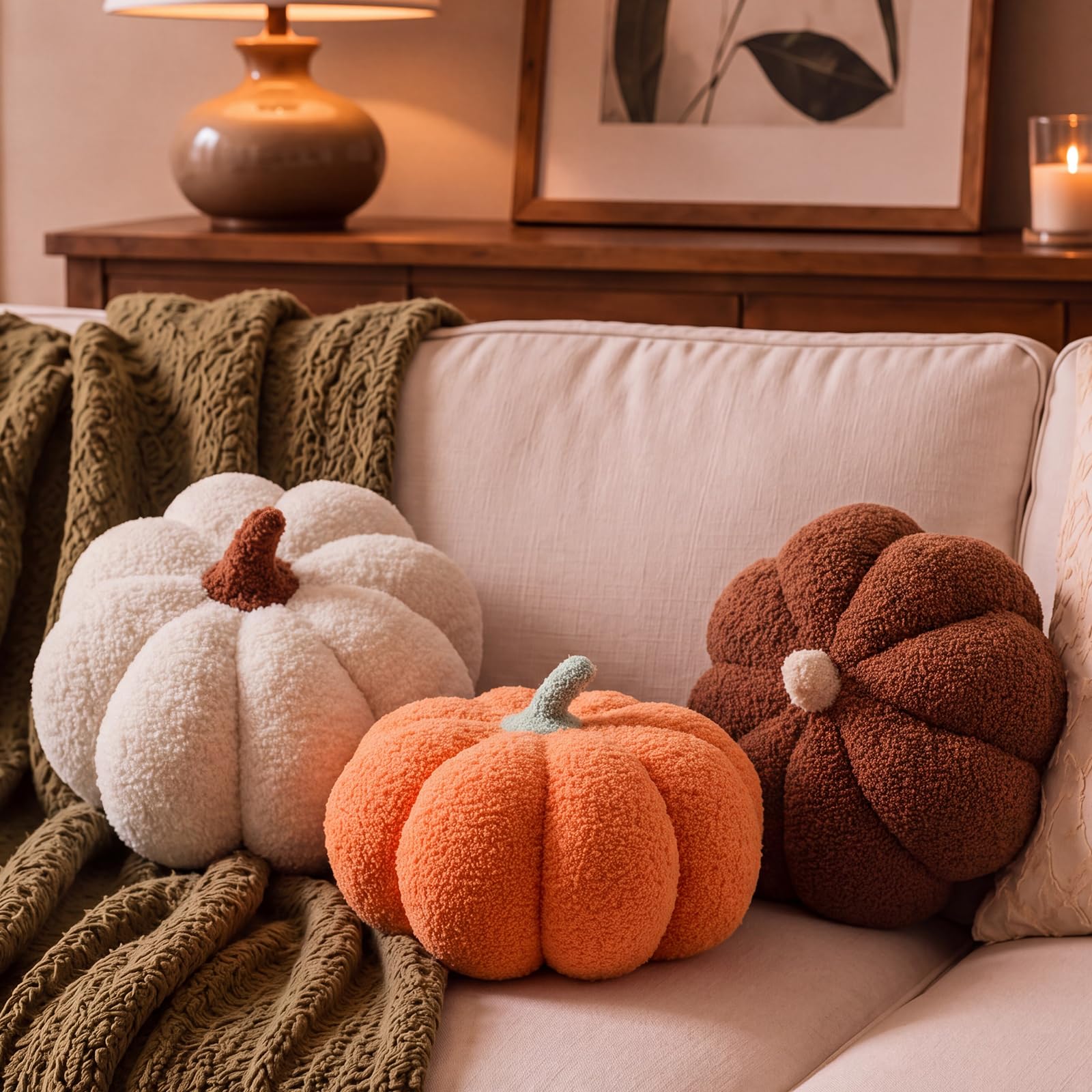 Juexica front view of three pumpkin pillows adding fall color and warmth