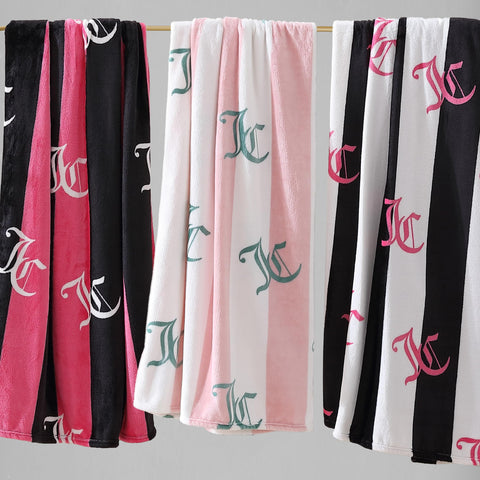 Juicy Couture throw layered at bed foot showing warm, fashionable accent