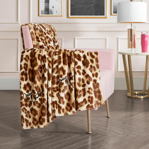 Juicy Couture folded throw on sofa adding chic protection and warmth