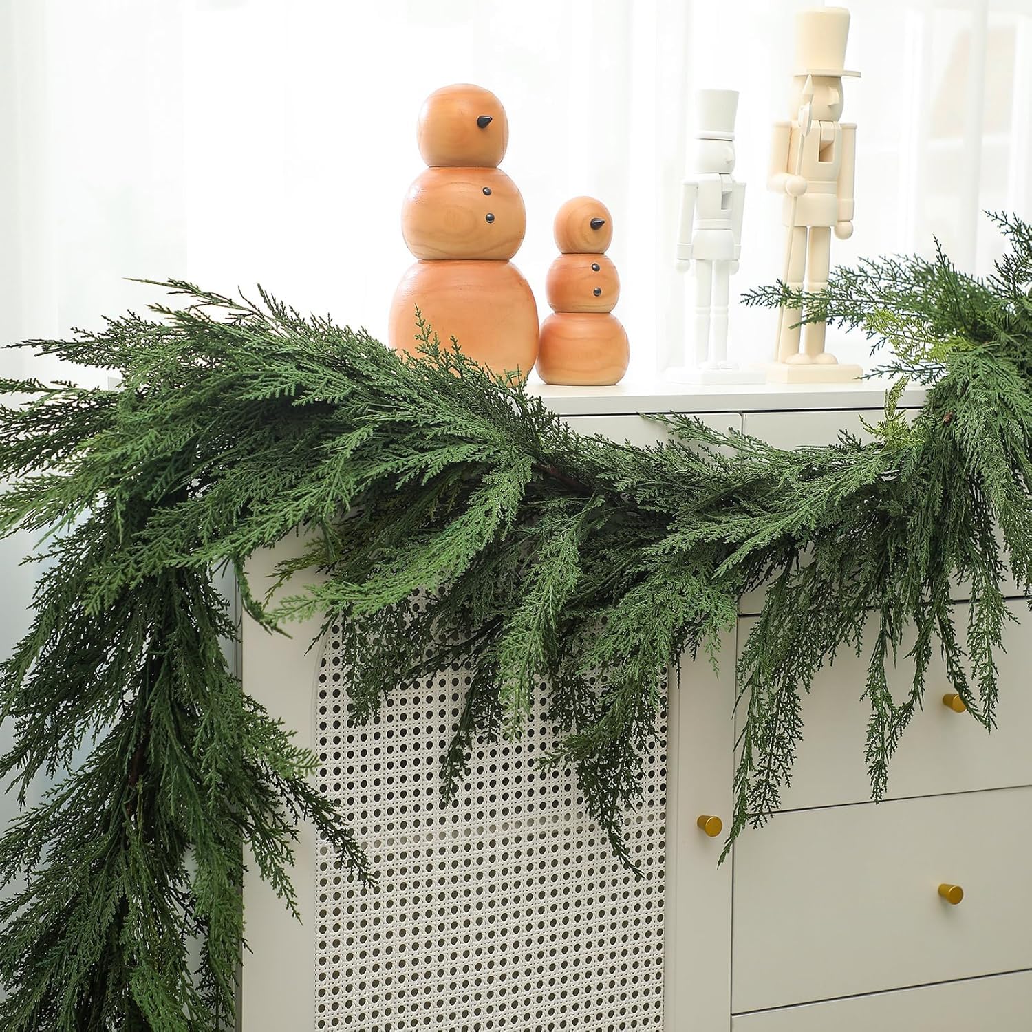 Jutom mantel display with garland enhances holiday focal point and warmth
