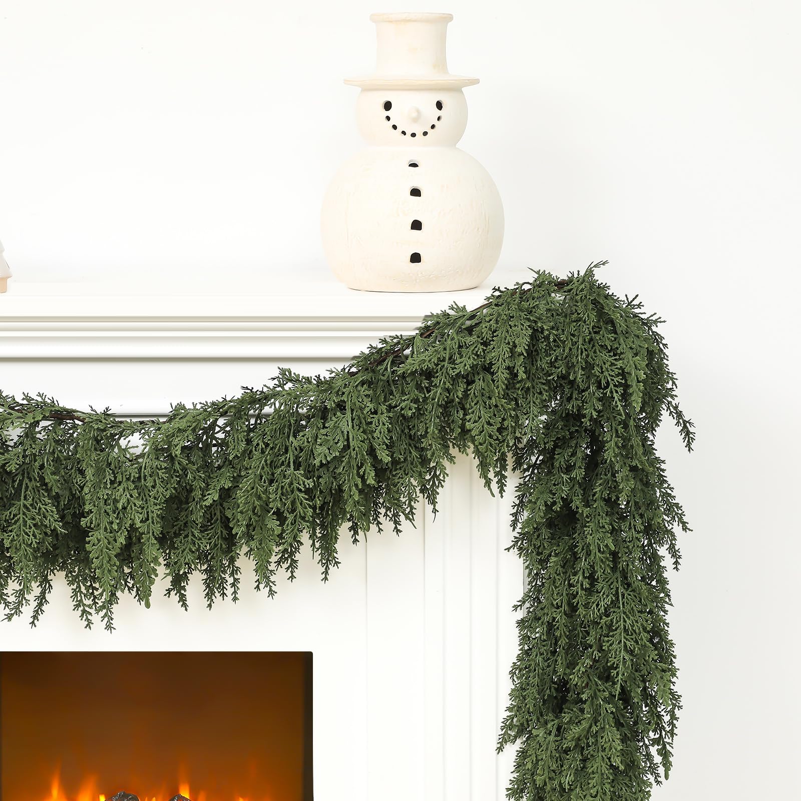Jutom garland draped on mantel decorated with lights adding warm holiday atmosphere