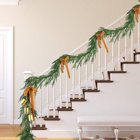Jutom garland styled along staircase rail adding cohesive holiday charm