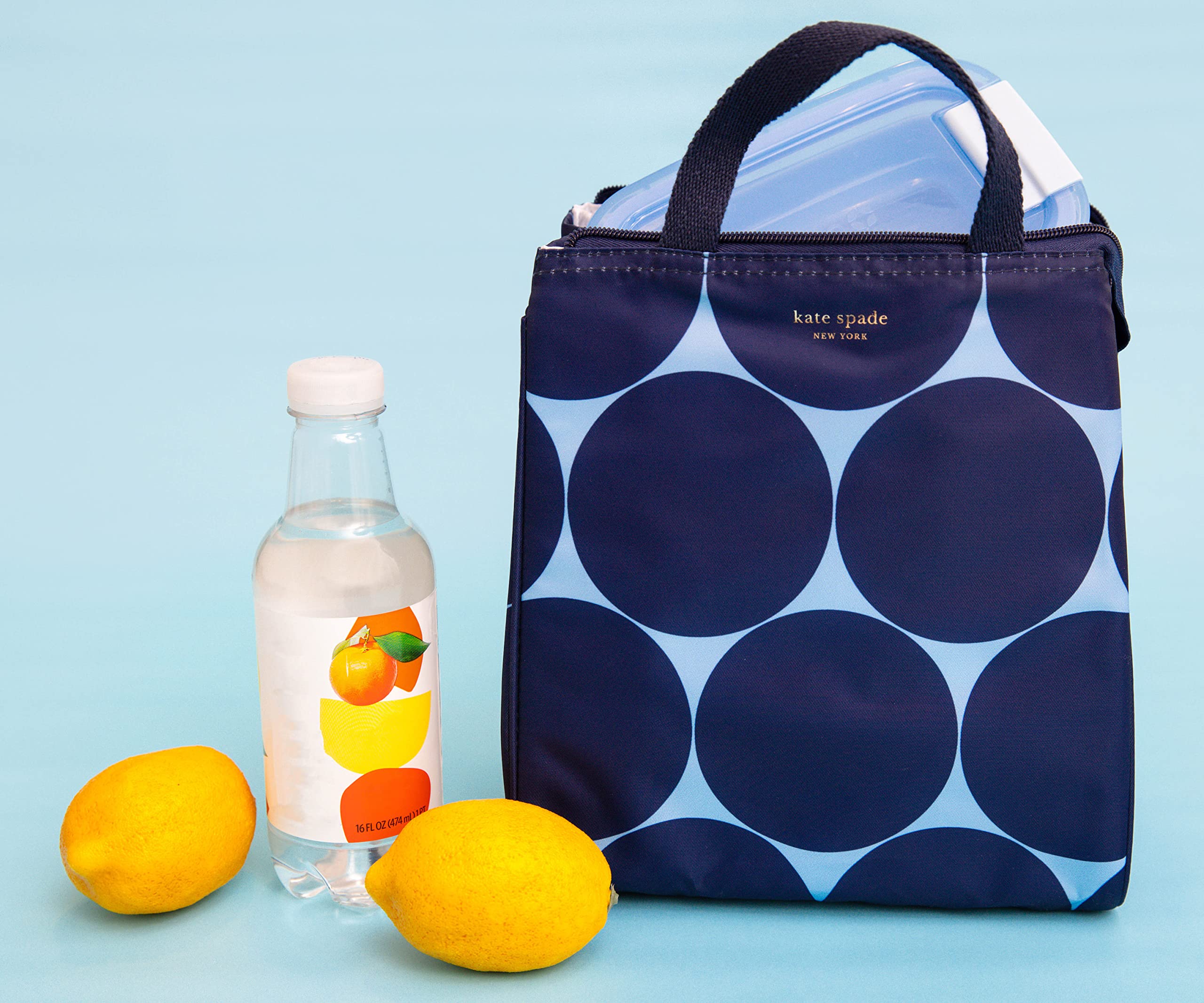kate spade new york lunch bag in use on a commuter bench demonstrating portable convenience