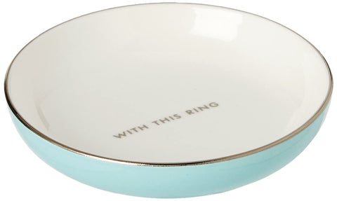 kate spade new york ring holder beside a lipstick for scale and decorative bedside use