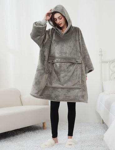 KFUBUO hoodie blanket worn by model lounging on sofa demonstrating relaxed use