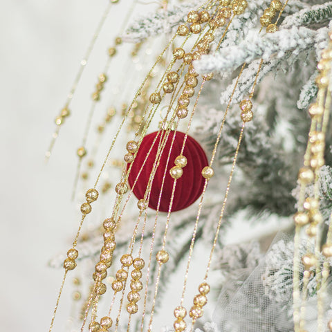 KI Store ornaments hung on tree showing rich burgundy coordinating benefit