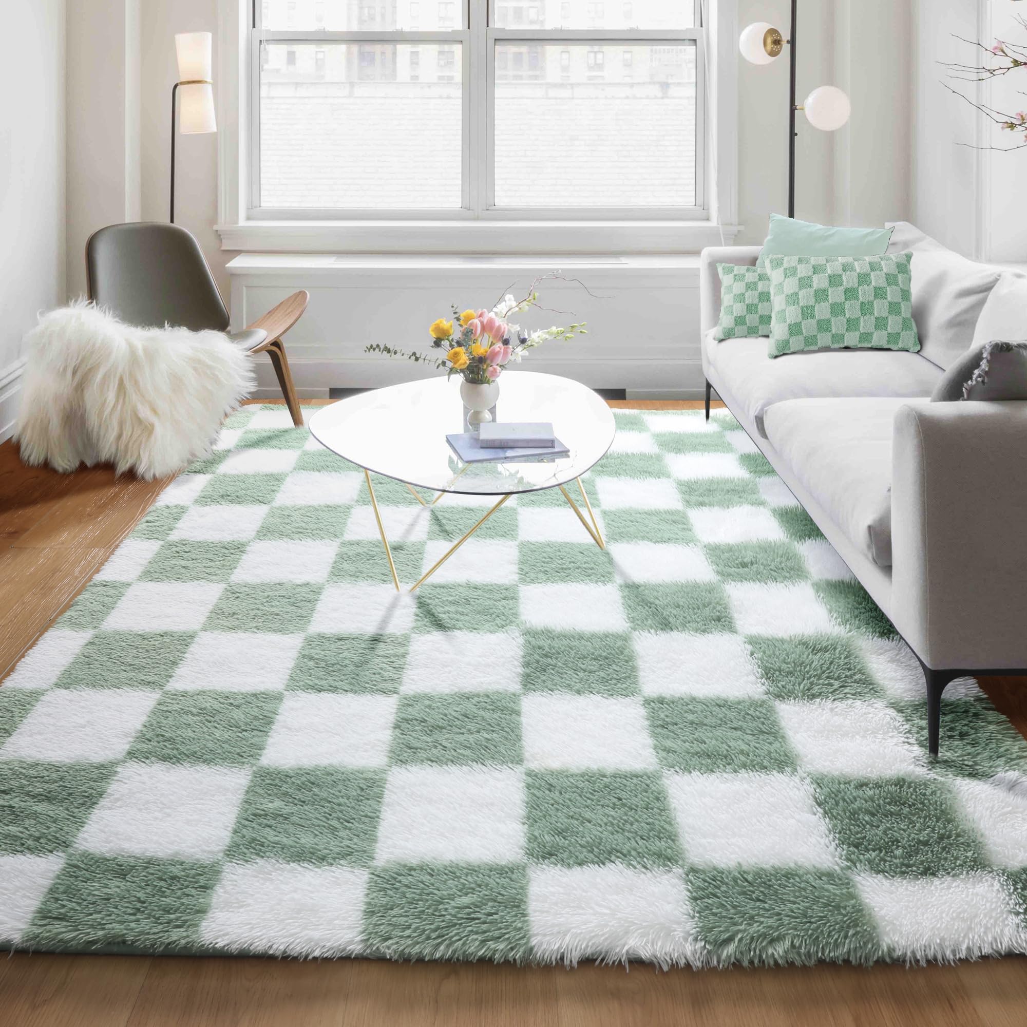 KICMOR rug scaled next to a sofa to illustrate true 5x8 size fit