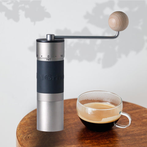 KINGrinder K6 in-use at campsite grinding beans for fresh coffee outdoors