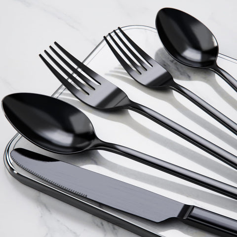 KINGSTONE black cutlery next to a hand for scale, showing comfortable weight