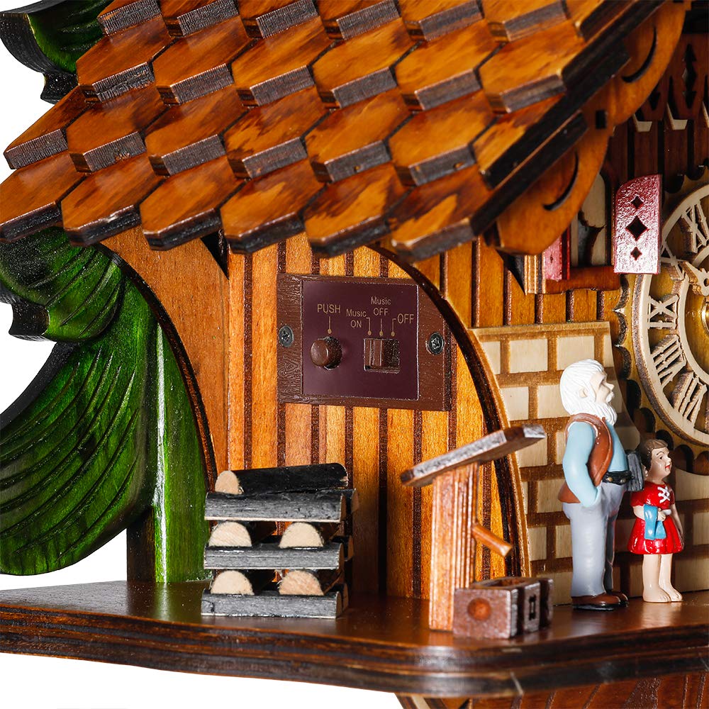 kintrot cuckoo clock beside book for scale showing compact size and wall-friendly fit