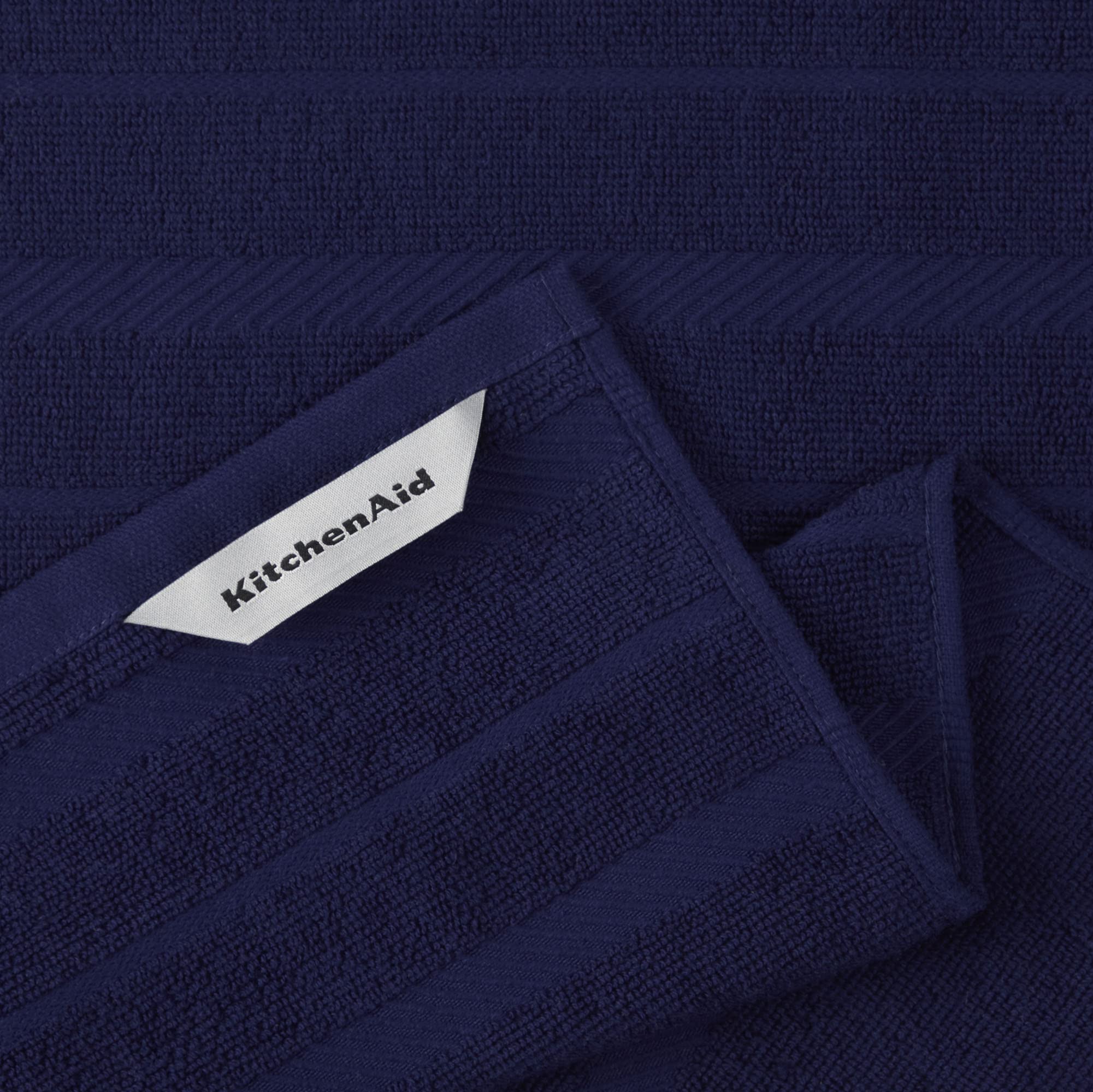 KitchenAid towel drying glassware to show effective dish drying and non-abrasive benefit
