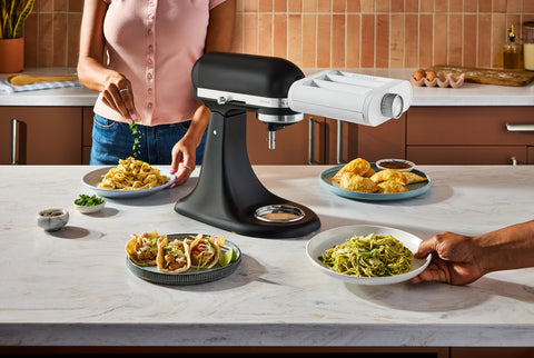 KitchenAid attachment mounted on a stand mixer enabling hands-free pasta production