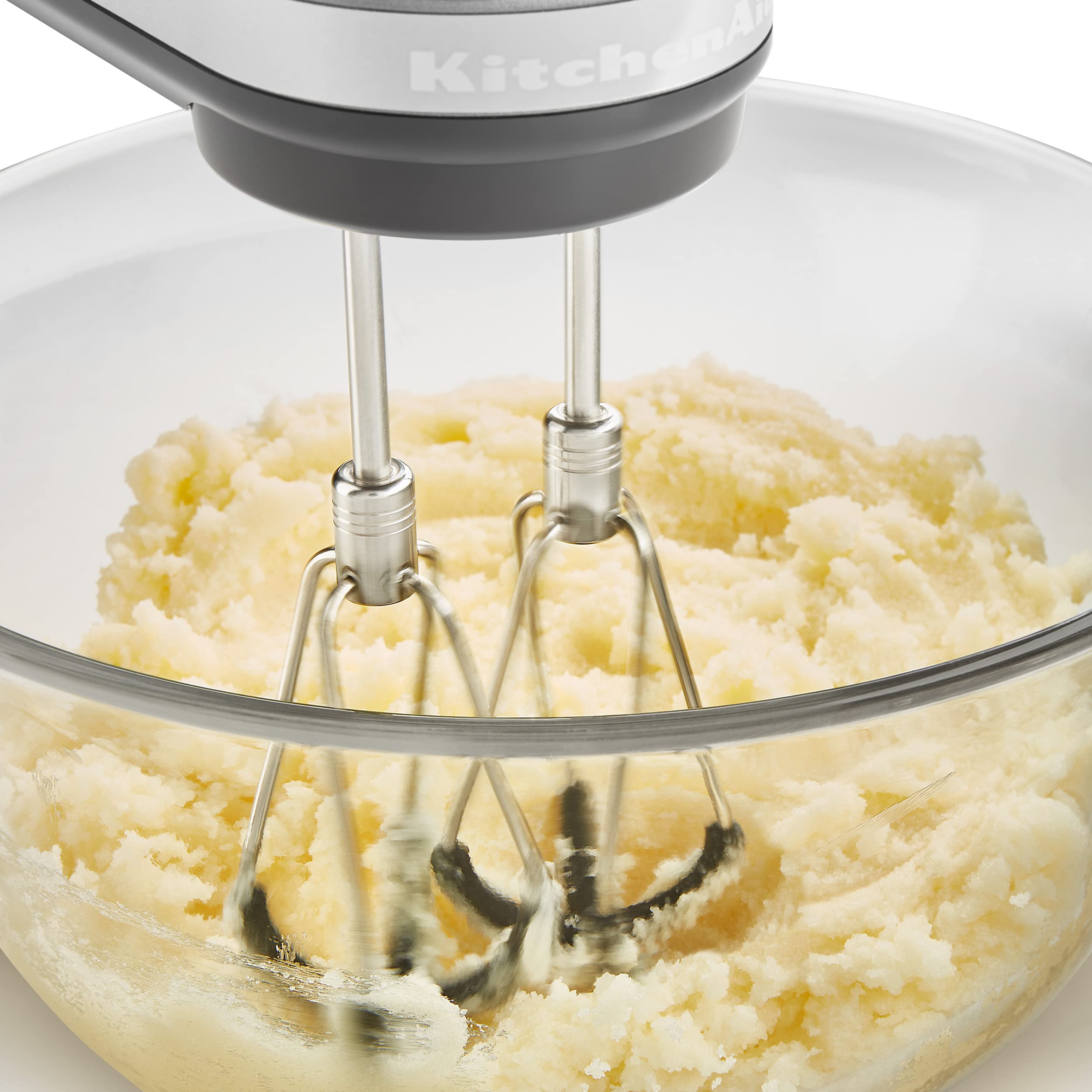 KitchenAid beaters held in hand showing size and scale for easy storage and handling