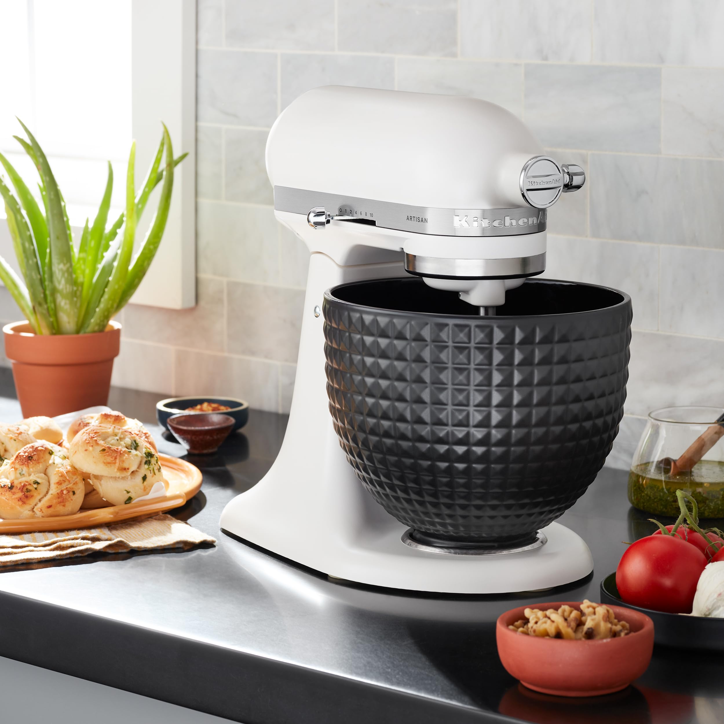KitchenAid bowl beside measuring cup showing 5-quart capacity and size reference
