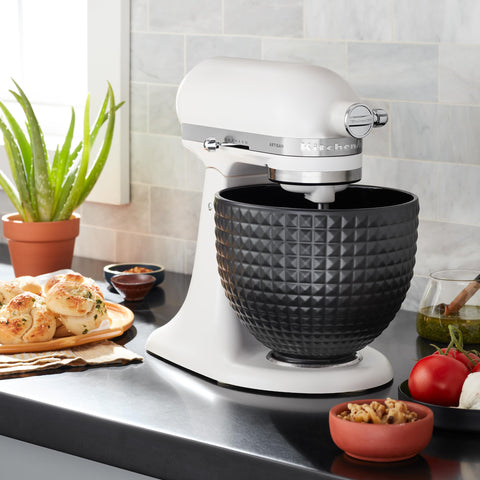 KitchenAid bowl beside measuring cup showing 5-quart capacity and size reference