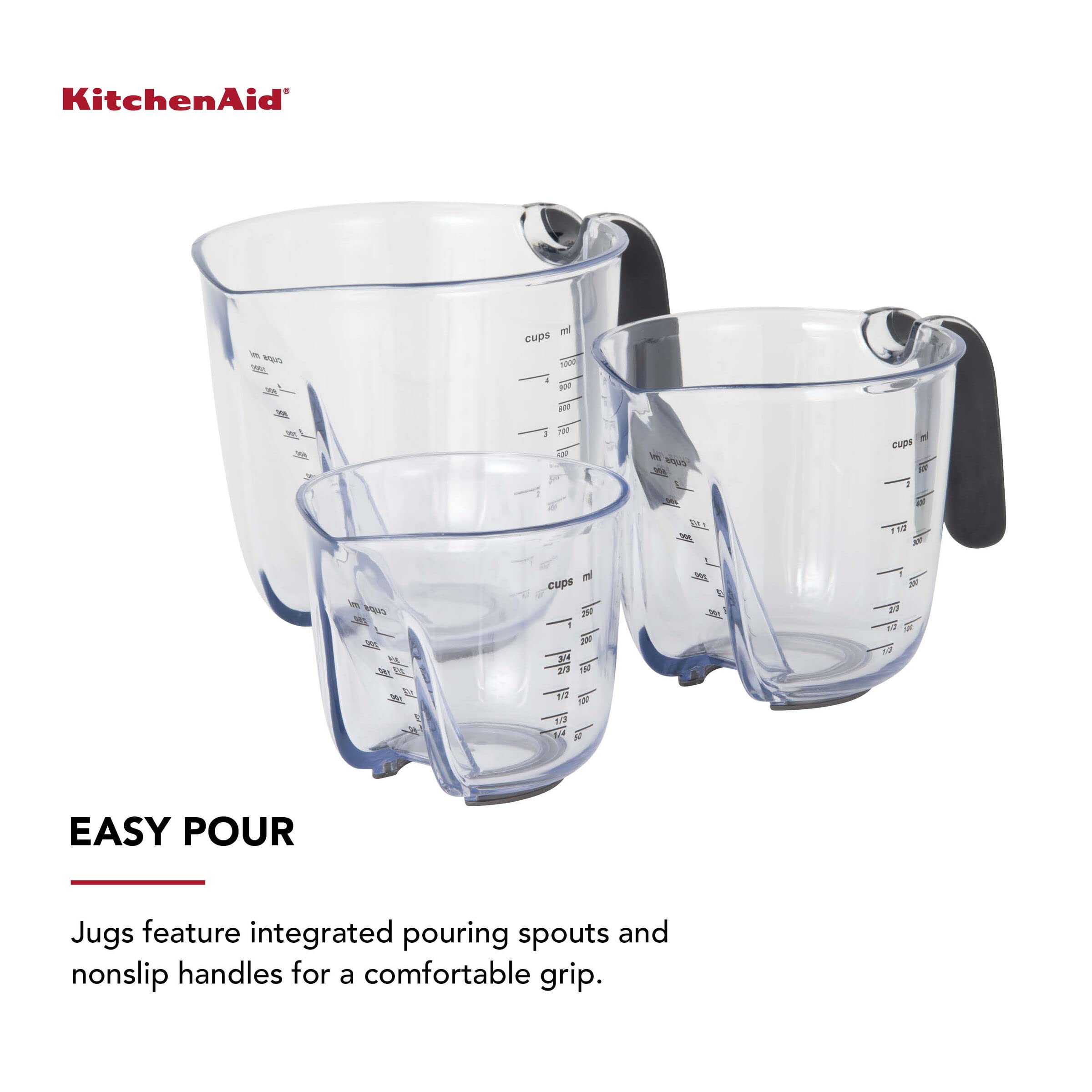 KitchenAid measuring cup pouring sauce into bowl for precise transfer
