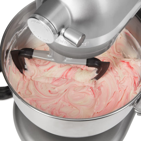 KitchenAid beater beside measuring cup showing compact size and compatibility