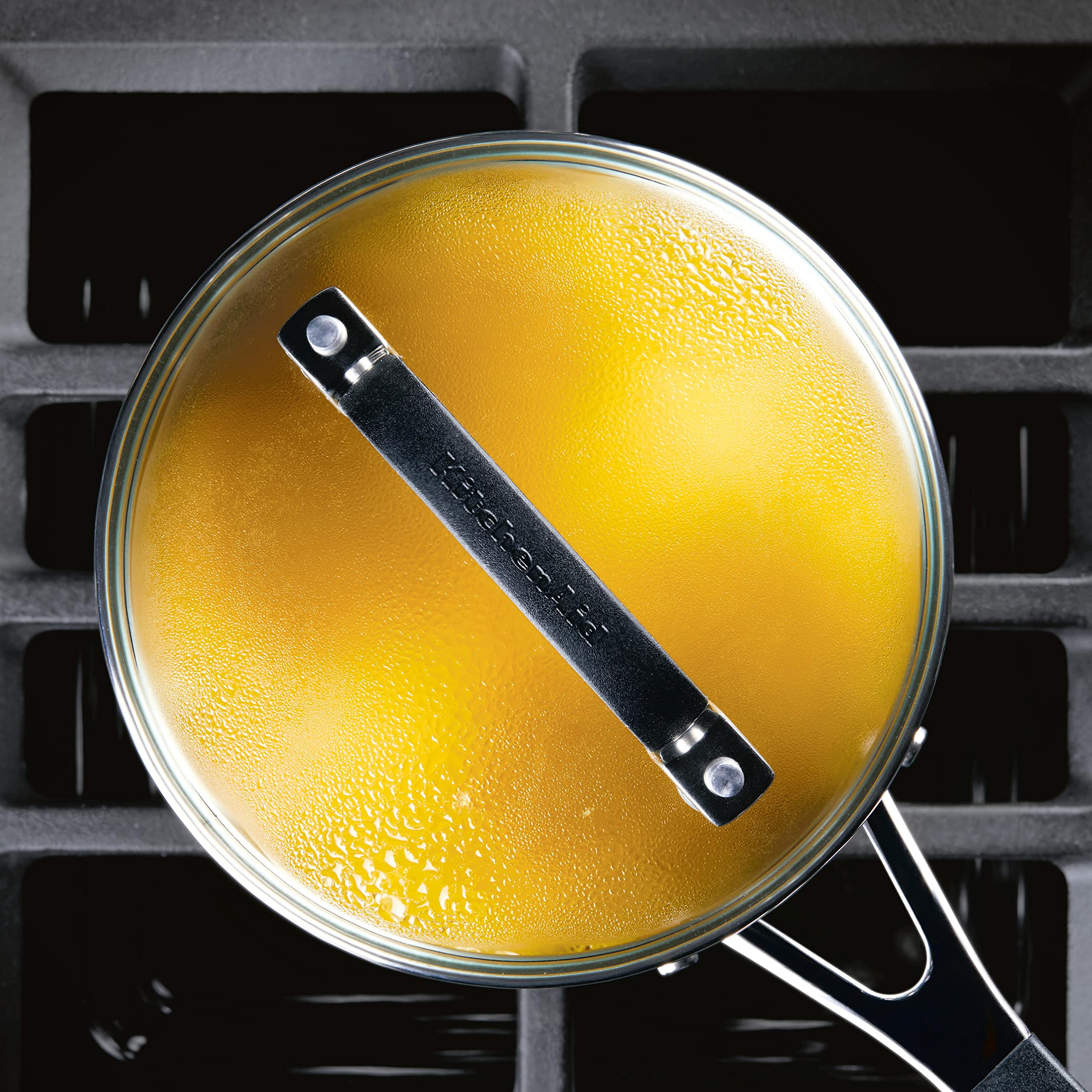 KitchenAid saucepan next to spoon showing compact two-quart scale