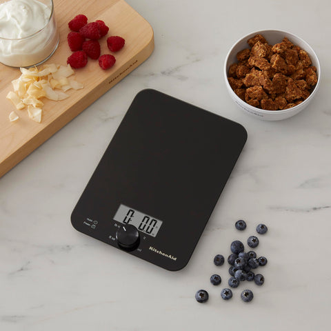 KitchenAid scale in use weighing bowl demonstrates tare function for multi-ingredient recipes