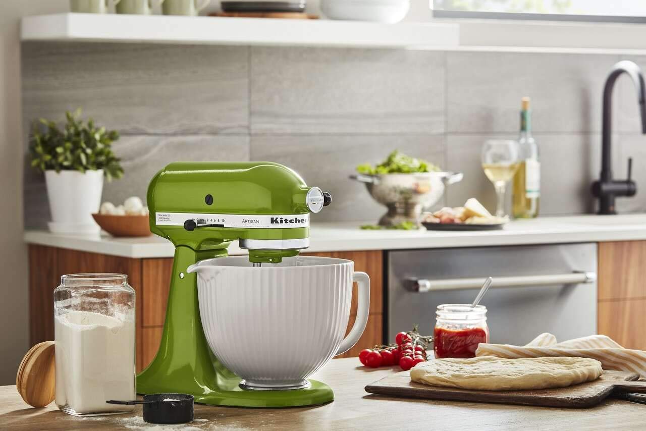 KitchenAid bowl next to measuring cup illustrating 5-quart capacity for larger batches
