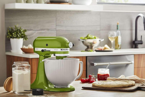KitchenAid bowl next to measuring cup illustrating 5-quart capacity for larger batches